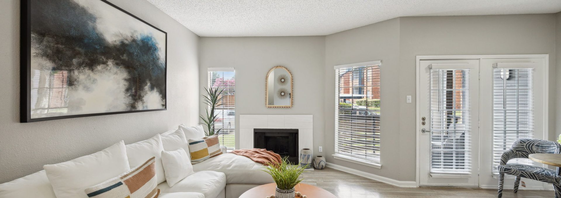 a living room with white walls and a large window at The  Dayton