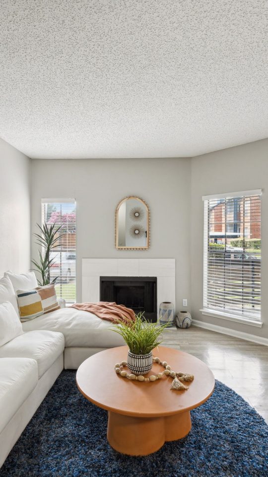 a living room with white walls and a large window at The  Dayton